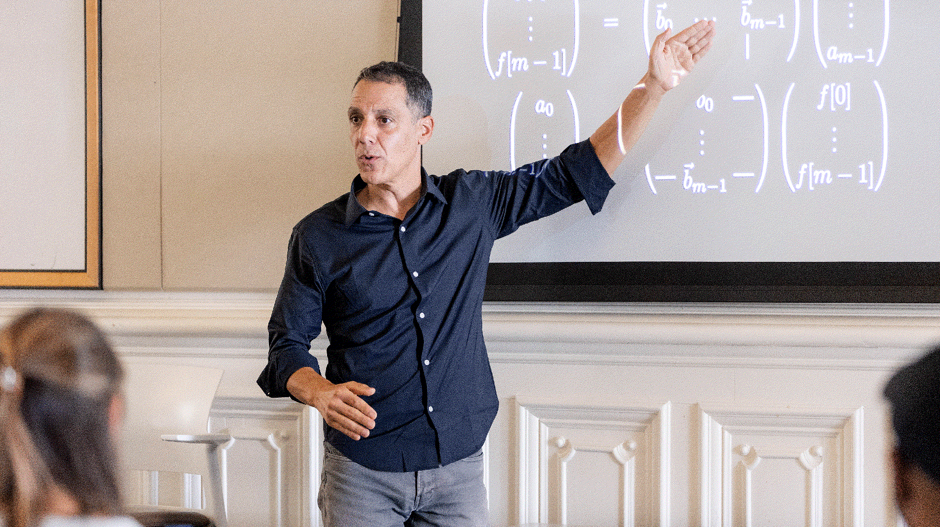 man in blue shirt pointing at the board