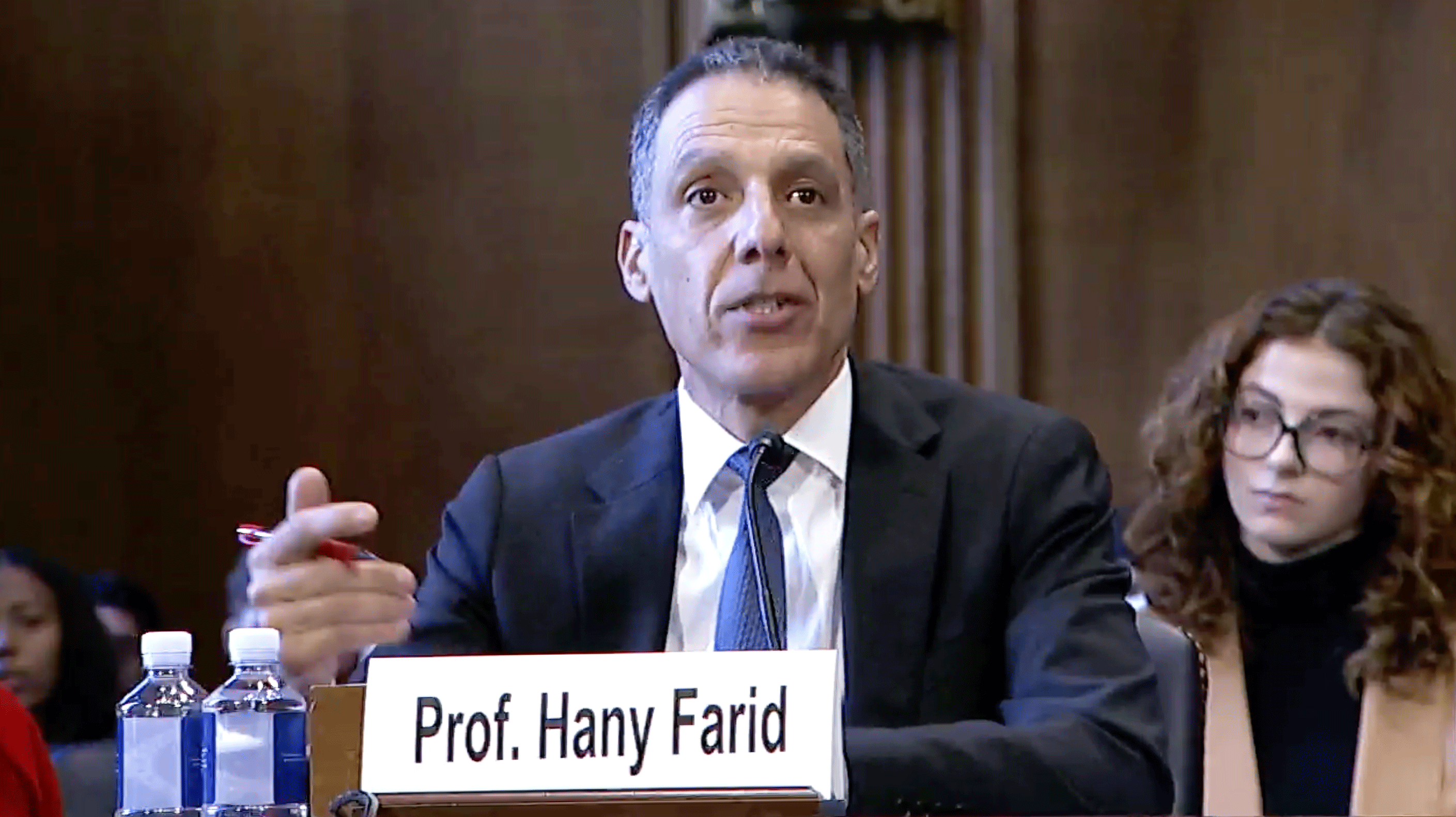Hany Farid sitting at a senate meeting