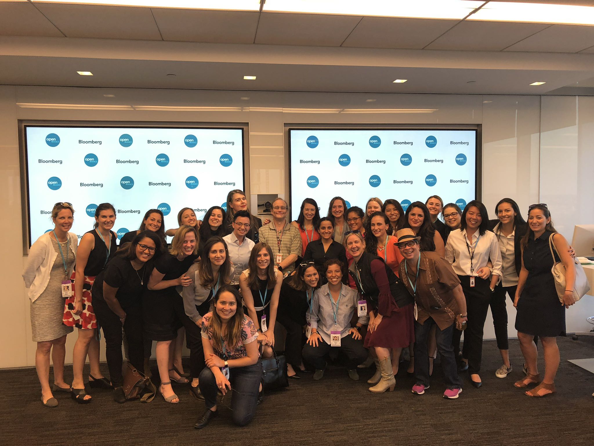 Christina Papadimitriou at an OPEN Finance Women event with the Women's Committee, hosted at Bloomberg; shows group photo against Bloomberg backdrop