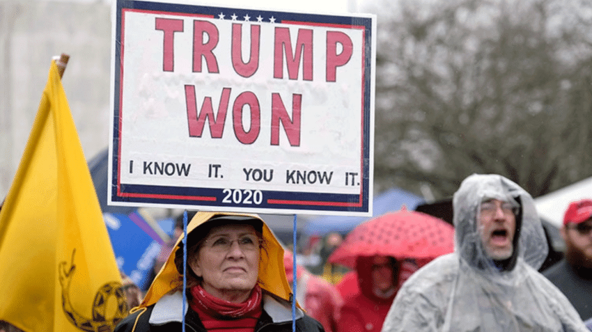 person holding sign saying trump won 2020