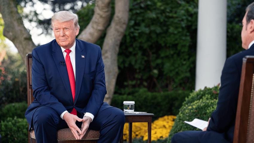 trump sitting in a chair in an interview