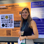 I School Student Sarah Barrington at Stanford conference in front of NFT poster