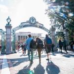 people walking in a blur by Sather Gate at UC Berkeley