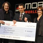 Ari Olmos (center) accepts the award from event host Jonathan Ross & Lee Epting of Vodafone