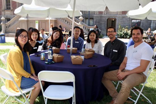 group of MIMS students at orientation sitting at an outdoor table