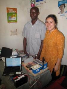 Melissa Ho and a WE CARE Solar kit at a clinic in rural Uganda