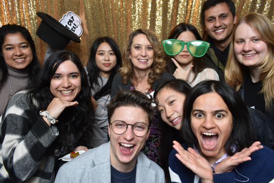 Students pose for a photobooth with Prof. Marti Hearst in the center