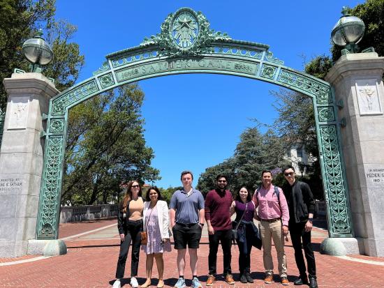 students pose in front of Sather Gate 