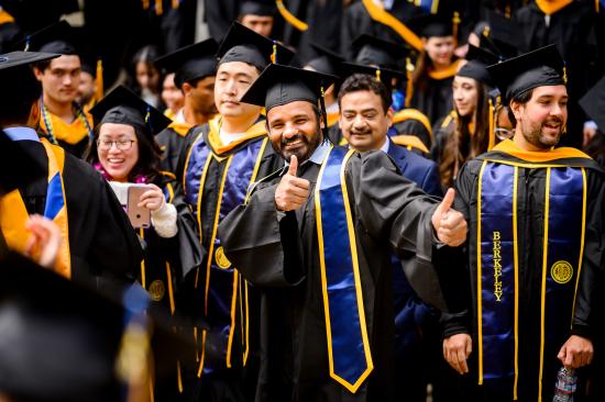 graduates giving thumbs up