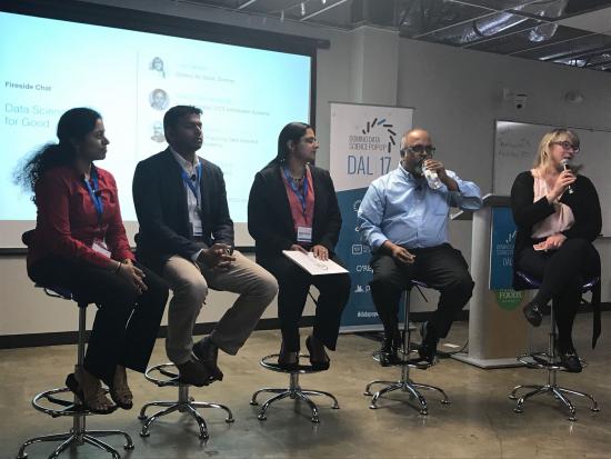 Sudha Subramanian part of a panel discussion fireside chat at a Domino Data Science Pop-Up in Dallas: Pictured: 5 individuals sitting on a panel