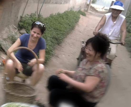Ph.D. student Elisa Oreglia (left) interviews local women in a village in China's Hebei province