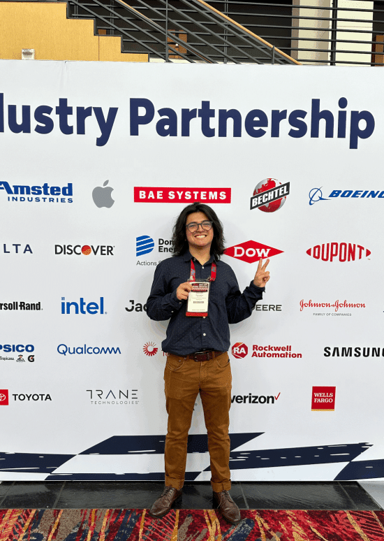 student smiling at a professional conference