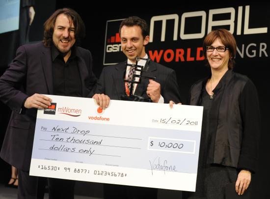 Ari Olmos (center) accepts the award from event host Jonathan Ross & Lee Epting of Vodafone