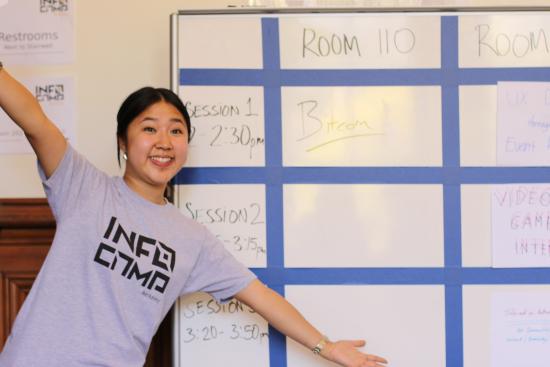 Jenny Lo, one of the InfoCamp organizers, with the schedule of participant-led sessions.