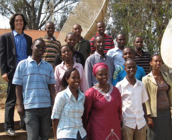 Josh Blumenstock (left) with 14 Rwandan university students who will be assisting with his research.