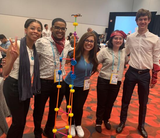 MICS 2022 RSAC Security Scholars Taylor Rainey (left) and Lauren Ayala (middle) team building with other security scholars.