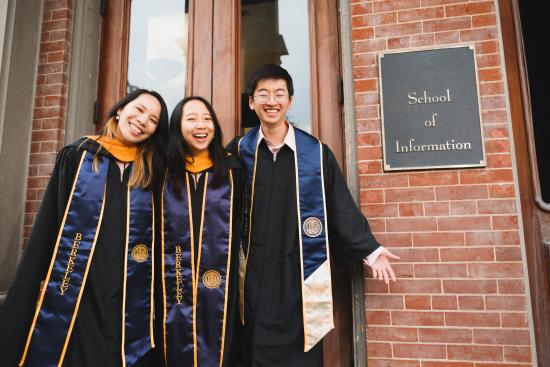 Nicole Chi, Joanne Ma, and Alex Gao pictured in MIMS Regalia in front of South Hall.
